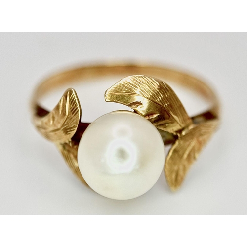 135 - AN 18K GOLD RING WITH A CENTRAL PEARL NESTLING IN BETWEEN FOLIAGE .  2gms    size J/K