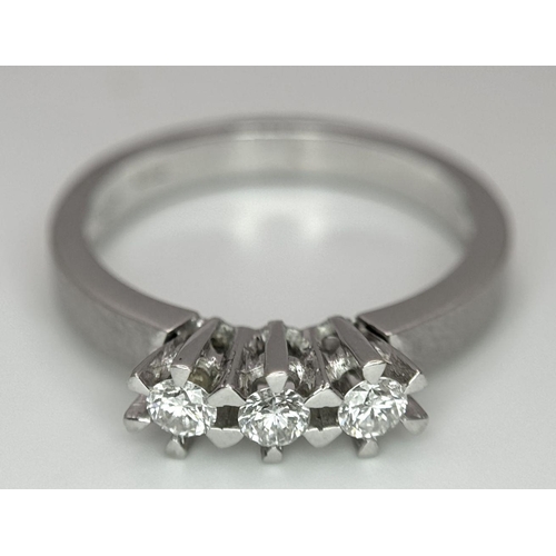 311 - A 18K White Gold Diamond 3 Stone Ring, 3.9g total weight, 0.21ct diamond, size M 1/2.

ref: 158I