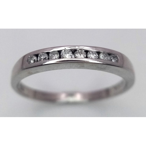 318 - A 18K White Gold Diamond 1/2 Eternity Ring, 2.7g total weight, 0.15ct diamond, size Q 1/2.

ref: 746... 