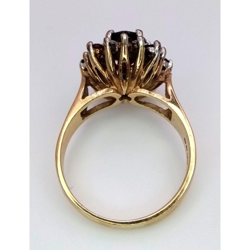 380 - A 9K Yellow Gold Garnet and Diamond Ring. Central oval garnet with diamond surround. Size J. 3.95g t... 