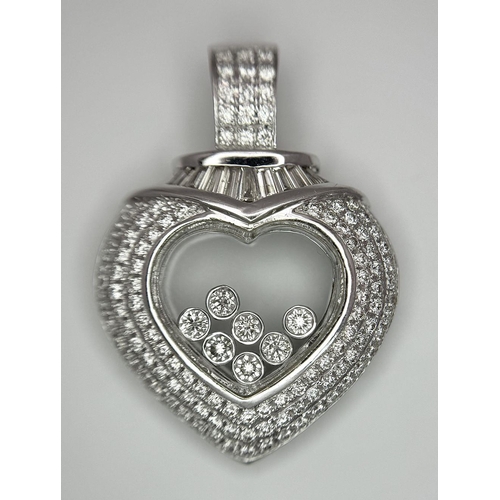 149 - A Beautiful 18K White Gold Diamond Encrusted Heart Pendant. Round and baguette cut diamonds with sev... 