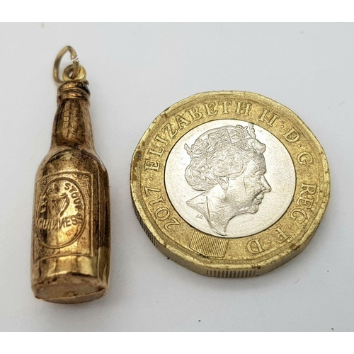 84 - 9 carat GOLD ‘BOTTLE of GUINNESS’ CHARM. 1.3 grams. 3 cm.