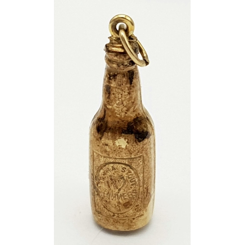 84 - 9 carat GOLD ‘BOTTLE of GUINNESS’ CHARM. 1.3 grams. 3 cm.