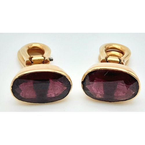 569 - A Pair of 18K Yellow Gold Garnet Earrings. Clip on. Oval cut deep red garnets. 4.3g