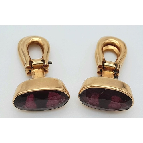 569 - A Pair of 18K Yellow Gold Garnet Earrings. Clip on. Oval cut deep red garnets. 4.3g