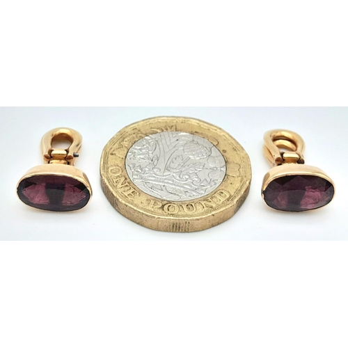 569 - A Pair of 18K Yellow Gold Garnet Earrings. Clip on. Oval cut deep red garnets. 4.3g