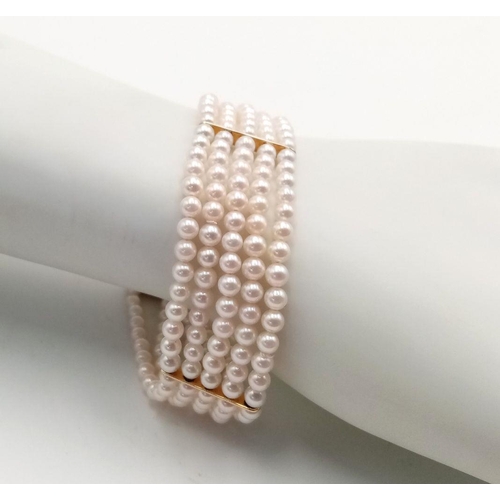 253 - A 9K Yellow Gold Five Row Small Pearl Bracelet. A beautiful pink hue on the pearls. Gold clasp and s... 