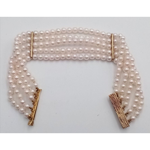 253 - A 9K Yellow Gold Five Row Small Pearl Bracelet. A beautiful pink hue on the pearls. Gold clasp and s... 