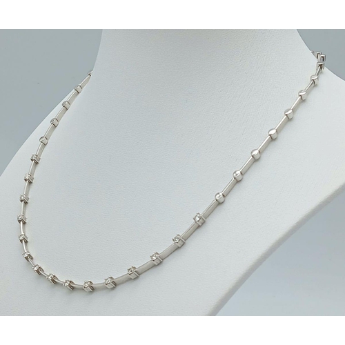 260 - An 18K White Gold Diamond Choker Necklace. 15 round cut diamonds. 17g total weight. 40cm. Ref: 01812... 