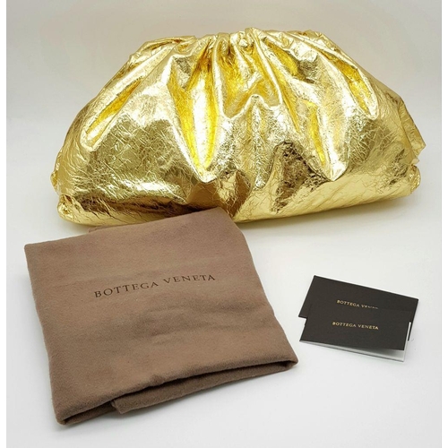 284 - A Bottega Veneta Gold Metallic Pouch Clutch Bag. Crinkled leather exterior with magnetic closure. Of... 