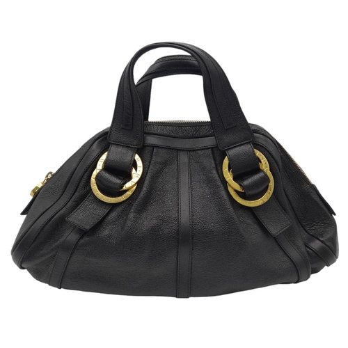 431 - A Bvlgari Black Polly Handbag. Black leather exterior with gold-toned hardware with two leather stra... 