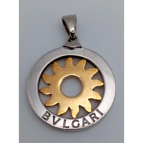 44 - A Bulgari 18K White and Yellow Gold Sun Pendant. 26mm diameter. 8.57g. Ref: 018124