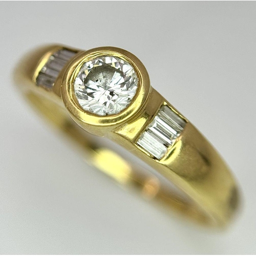 94 - An 18K Yellow Gold Diamond Ring. 0.33ct central diamond with small baguette diamonds on shoulders. S... 