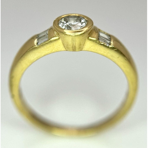 94 - An 18K Yellow Gold Diamond Ring. 0.33ct central diamond with small baguette diamonds on shoulders. S... 