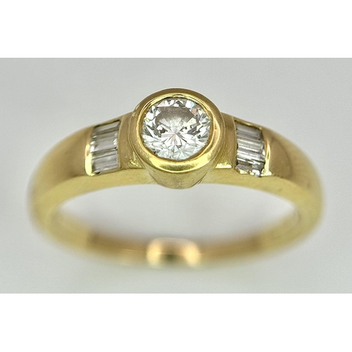 94 - An 18K Yellow Gold Diamond Ring. 0.33ct central diamond with small baguette diamonds on shoulders. S... 