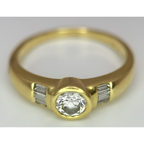 94 - An 18K Yellow Gold Diamond Ring. 0.33ct central diamond with small baguette diamonds on shoulders. S... 