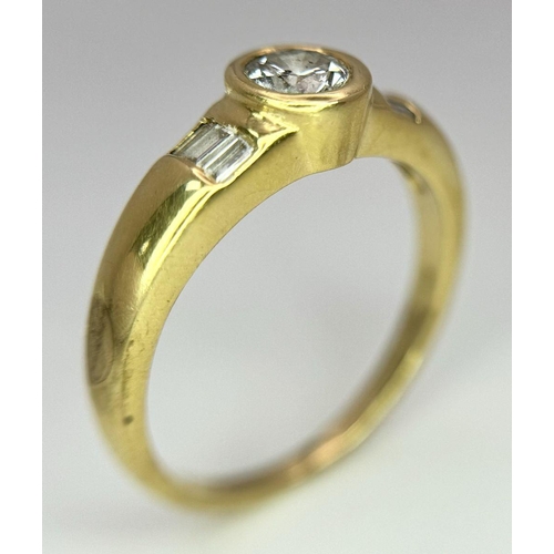 94 - An 18K Yellow Gold Diamond Ring. 0.33ct central diamond with small baguette diamonds on shoulders. S... 