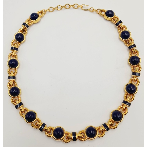 155 - A Designer Monet Gilded Necklace with Blue Stone Cabochon Decoration. 42cm.