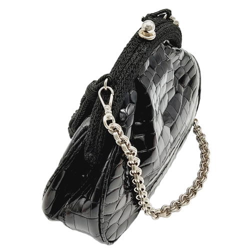 249 - A Prada Black Coccodrillo Evening Bag. Crocodile leather exterior with silver-toned hardware, textil... 