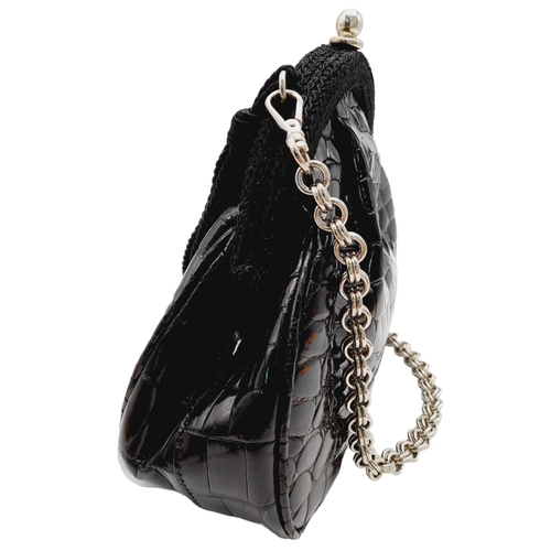 249 - A Prada Black Coccodrillo Evening Bag. Crocodile leather exterior with silver-toned hardware, textil... 