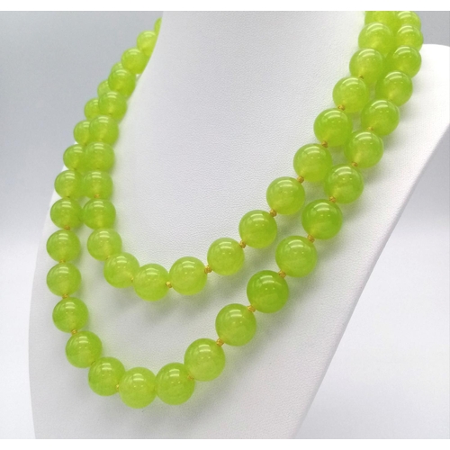 292 - A Lovely Summer Matinee Length Apple Coloured Peridot Necklace. 90cm length with 12mm beads.