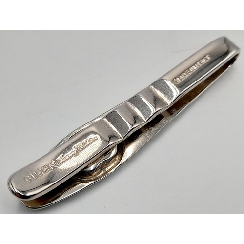 106 - A Vintage Gucci Tie Clip. White metal with Gucci monogram. Fitted Gucci case and COA.