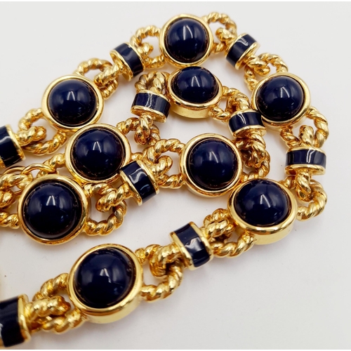 155 - A Designer Monet Gilded Necklace with Blue Stone Cabochon Decoration. 42cm.