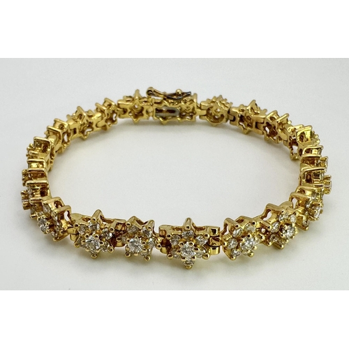 267 - An 18K Yellow Gold Diamond Tennis Bracelet. Floral form with 154 round cut diamonds - 4.18ctw. 16cm.... 