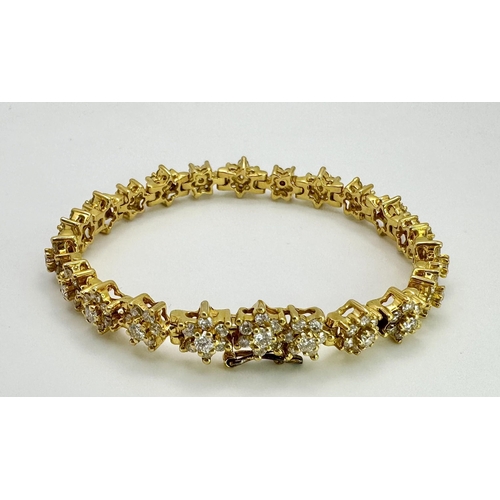 267 - An 18K Yellow Gold Diamond Tennis Bracelet. Floral form with 154 round cut diamonds - 4.18ctw. 16cm.... 