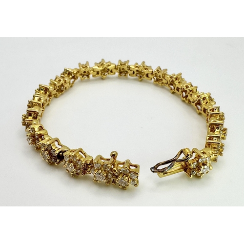 267 - An 18K Yellow Gold Diamond Tennis Bracelet. Floral form with 154 round cut diamonds - 4.18ctw. 16cm.... 