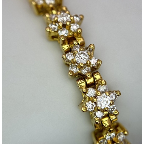 267 - An 18K Yellow Gold Diamond Tennis Bracelet. Floral form with 154 round cut diamonds - 4.18ctw. 16cm.... 