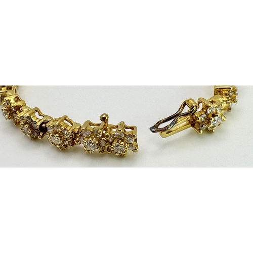 267 - An 18K Yellow Gold Diamond Tennis Bracelet. Floral form with 154 round cut diamonds - 4.18ctw. 16cm.... 