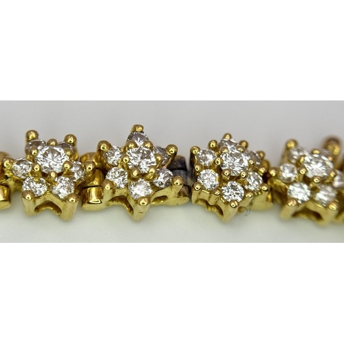 267 - An 18K Yellow Gold Diamond Tennis Bracelet. Floral form with 154 round cut diamonds - 4.18ctw. 16cm.... 