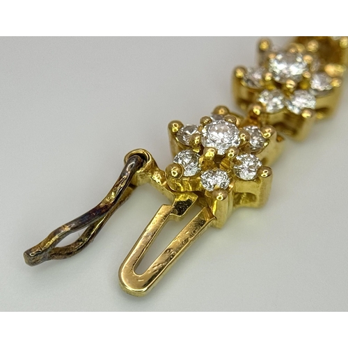 267 - An 18K Yellow Gold Diamond Tennis Bracelet. Floral form with 154 round cut diamonds - 4.18ctw. 16cm.... 