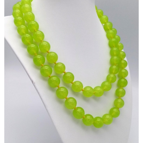 292 - A Lovely Summer Matinee Length Apple Coloured Peridot Necklace. 90cm length with 12mm beads.