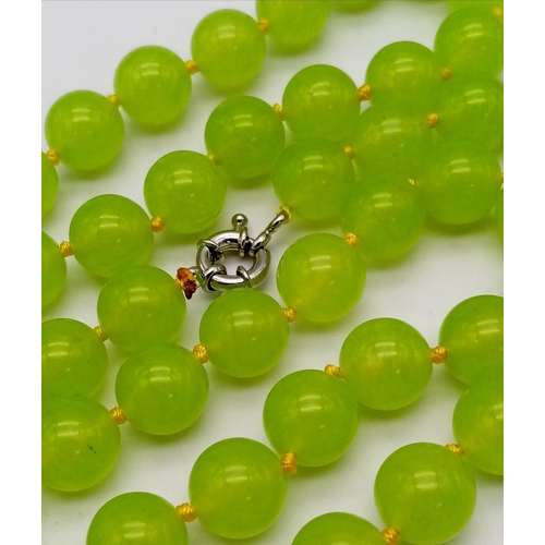 292 - A Lovely Summer Matinee Length Apple Coloured Peridot Necklace. 90cm length with 12mm beads.