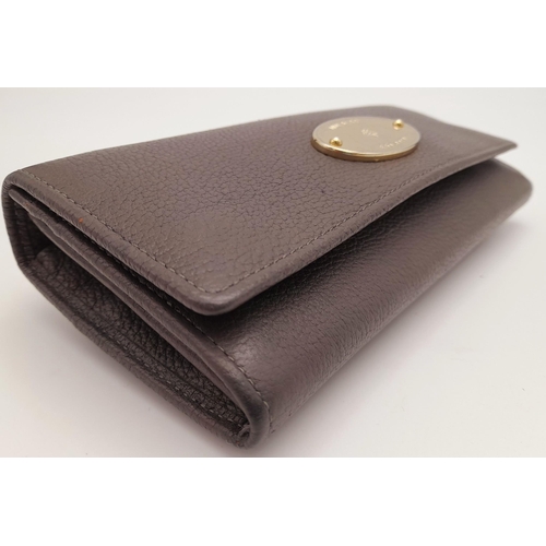 354 - A Mulberry Khaki Continental Wallet. Leather exterior with a zipped compartment to back and double p... 