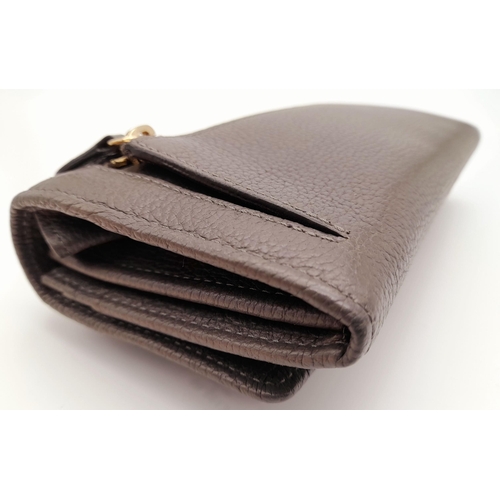 354 - A Mulberry Khaki Continental Wallet. Leather exterior with a zipped compartment to back and double p... 