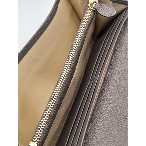 354 - A Mulberry Khaki Continental Wallet. Leather exterior with a zipped compartment to back and double p... 