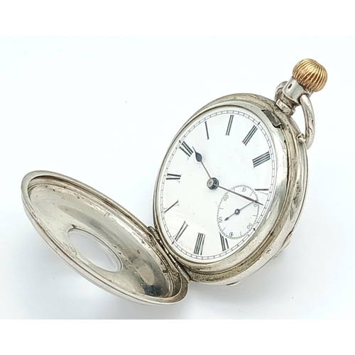 400 - A Silver Half Hunter Pocket Watch. Hallmarks. In working order but because of age no guarantees. 94g... 