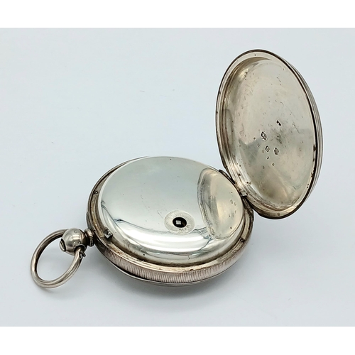 407 - A Silver Pocket Watch. Hallmarks. Comes with key. In working order but because of age no guarantees.... 