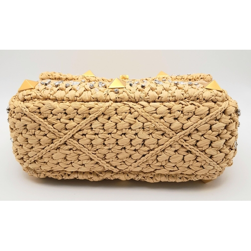 206 - A Valentino Beige Roman Bag. Woven raffia, crystal and stud embellished exterior with gold-toned har... 