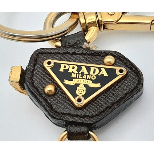 234 - A Prada Furry Keyring. Gold-toned hardware with a tough leather body and furry finish. Comes with du... 