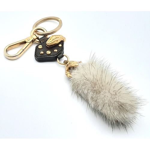 234 - A Prada Furry Keyring. Gold-toned hardware with a tough leather body and furry finish. Comes with du... 