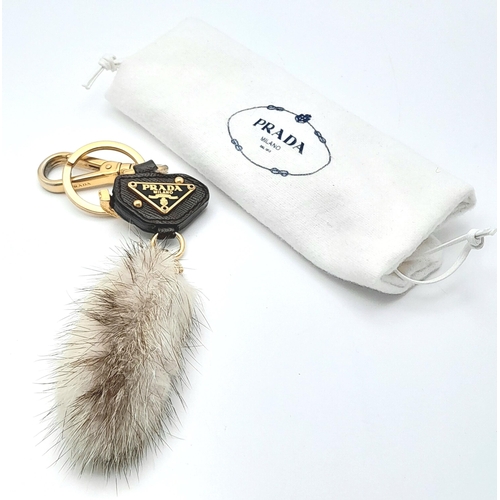 234 - A Prada Furry Keyring. Gold-toned hardware with a tough leather body and furry finish. Comes with du... 