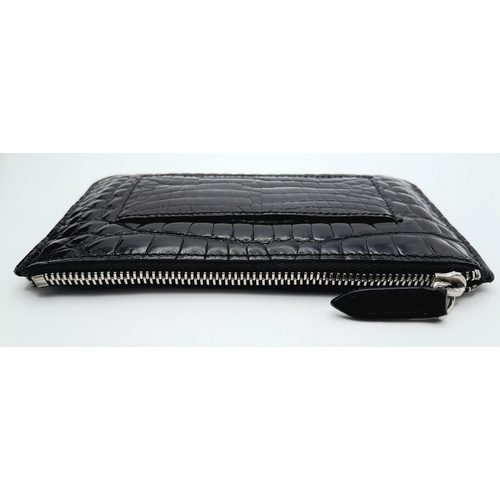 241 - An Asprey Black Coin Purse. Crocodile leather exterior with silver-toned hardware and zip top closur... 