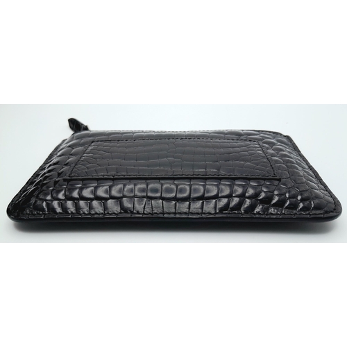 241 - An Asprey Black Coin Purse. Crocodile leather exterior with silver-toned hardware and zip top closur... 