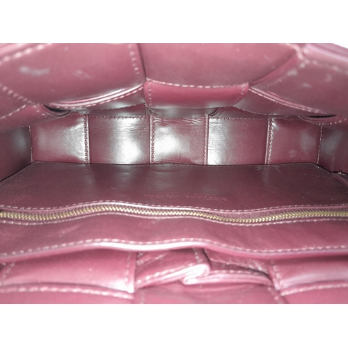 291 - A Bottega Veneta Brick Cassette Bag. Smooth burgundy leather, signature orthogonal weaving, adjustab... 