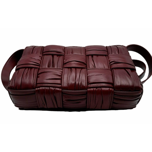 291 - A Bottega Veneta Brick Cassette Bag. Smooth burgundy leather, signature orthogonal weaving, adjustab... 