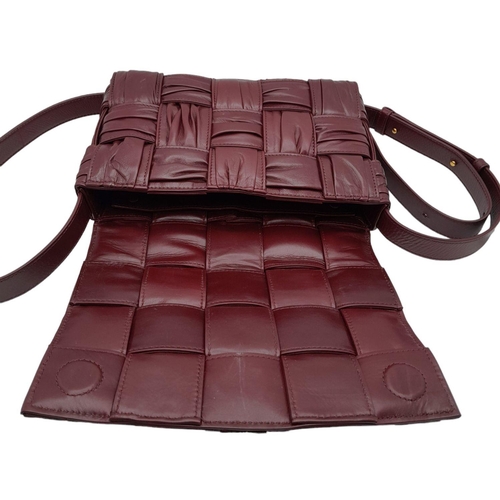 291 - A Bottega Veneta Brick Cassette Bag. Smooth burgundy leather, signature orthogonal weaving, adjustab... 